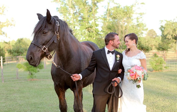 Newlywed couple with a horse
