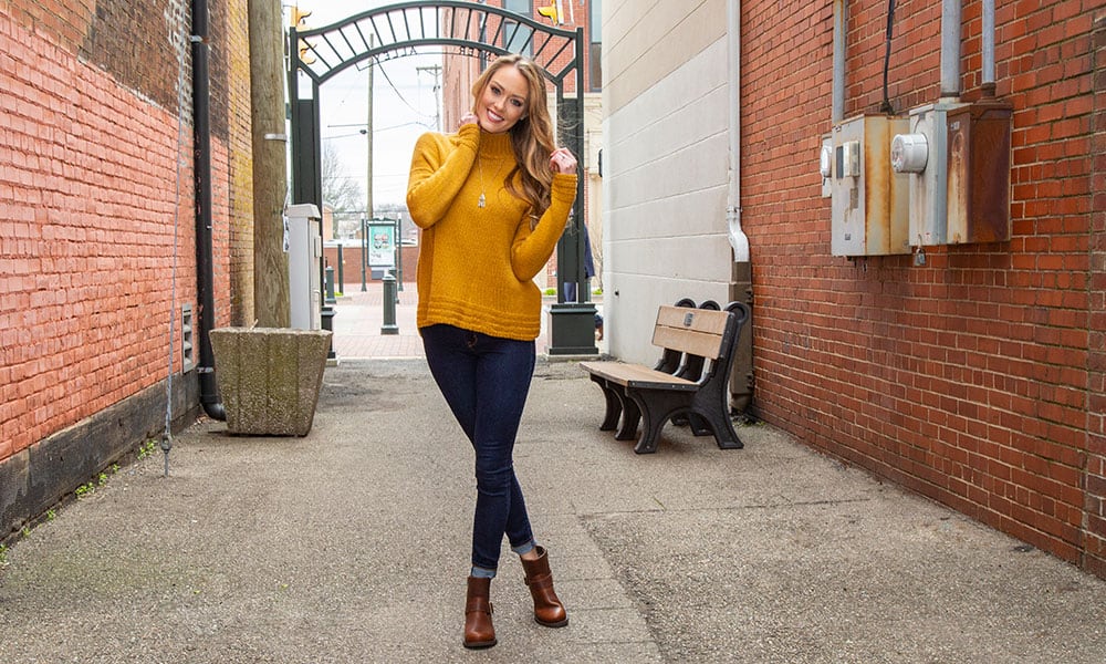 durango brown crush booties girl with yellow sweater jeans alleyway