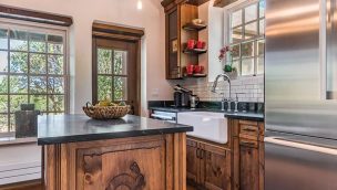 farmhouse sink in a wooden kitchen with a fridge cowgirl magazine