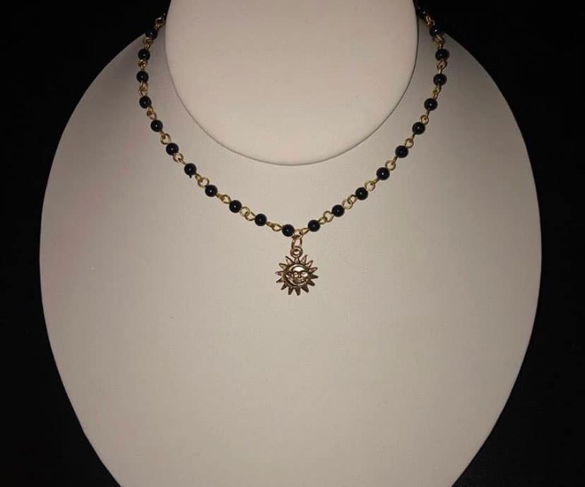 black eclipse necklace with sun charm